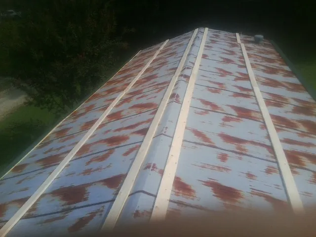 Rusted metal roof panels with new wood purlins before replacement — Storm Damage Roof Repair in Canyon by Roofing Brothers